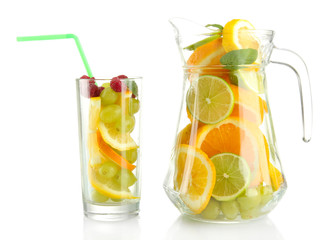 transparent jar and glass with citrus fruits and raspberries,