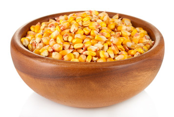 Corn in wooden bowl isolated on white