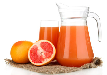 Full glass and jug of grapefruit juice and grapefruits isolated