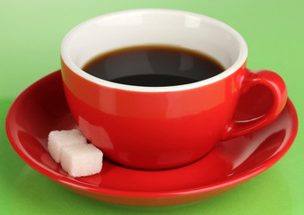 A cup of strong coffee on green background
