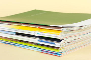 Many magazines on beige background