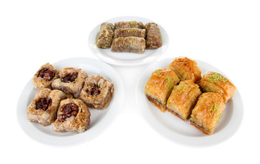 Sweet baklava on plates isolated on white