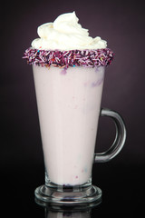 Delicious milk shake on dark purple background