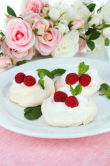 Tasty meringue cakes with berries, close up