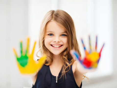 smiling girl showing painted hands