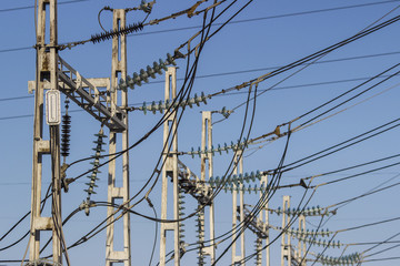 high voltage transmission pylon on blue sky background