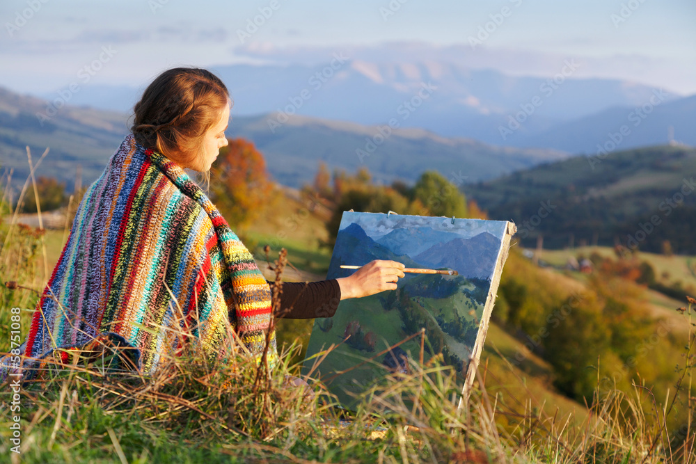 Wall mural young artist painting an autumn landscape