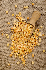 yellow pea on a wooden shovel