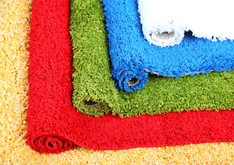 Many carpets of different colors close-up