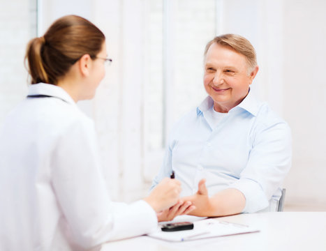 female doctor or nurse measuring blood sugar value