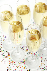 Glasses with champagne on shiny background