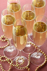 Glasses with champagne on shiny background