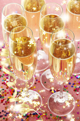 Glasses with champagne on shiny background