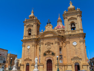Xaghra church with statues at its entrance in Gozo, Malta.