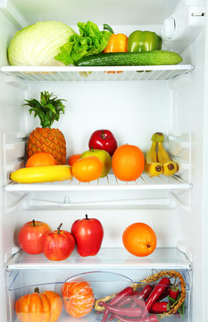 Vegetables and fruits in open refrigerator. Weight loss diet