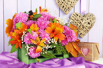 Flowers composition in crate with decorations