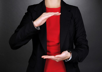 Female hands showing something on grey background