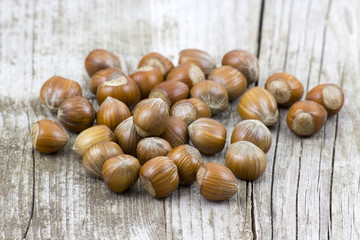 hazelnuts on old wooden background
