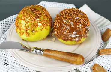 Homemade taffy apples, on napkin, on wooden background
