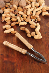 Nutcracker with nuts on wooden table close-up