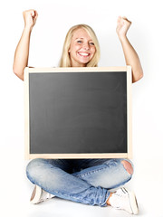 Smiling woman with blackboard shows thumbs up
