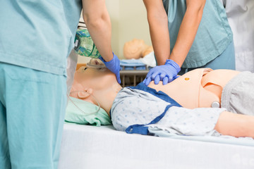 Nurse Performing CPR On Dummy Patient