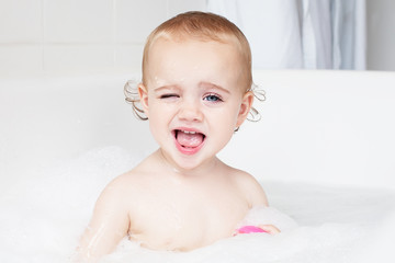 Portrait of a little girl taking a bath