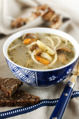 Homemade soup with mushrooms and spaghetti
