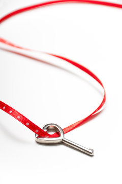 Heart shaped key and red ribbon