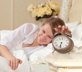 Woman's hand off the alarm clock