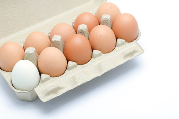 white and brown eggs in a carton package