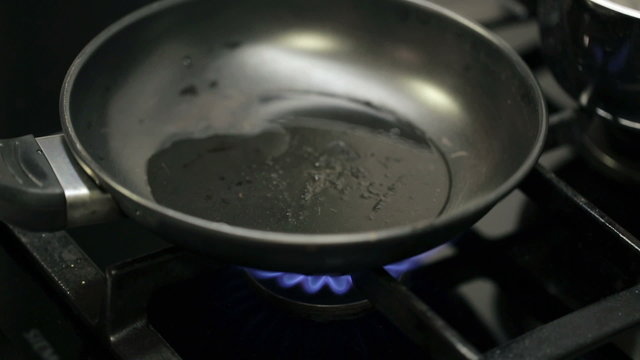 Putting frying pan on burning gas stove
