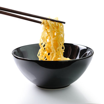 chopsticks holding noodles isolated on white background