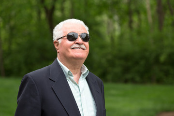 Senior Male Adult Looking up Trustfully with his Sunglasses