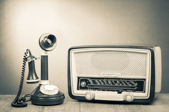 Vintage radio and telephone on table old style photo