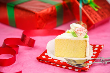 Cake  against red gift boxes