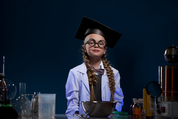 Image of cute little girl posing in graduate hat