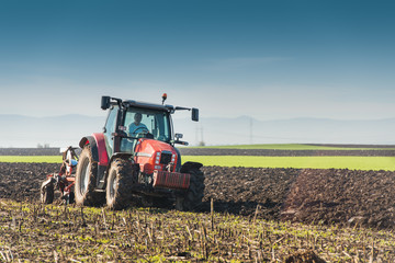 Tractor plowing field