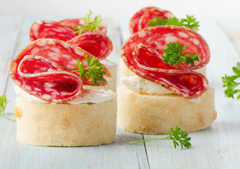 Baguette with salami and cream cheese with herbs.