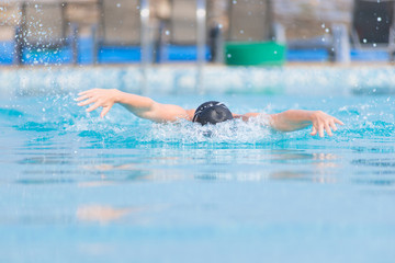 Young girl swimming butterfly stroke style