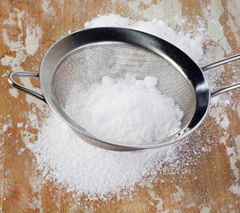 Powdered sugar in a metal sieve