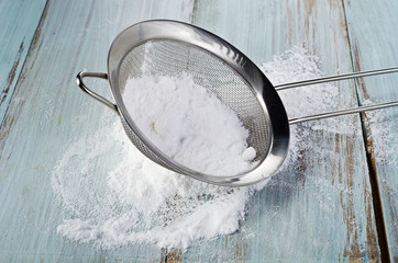 Powdered sugar in a metal sieve