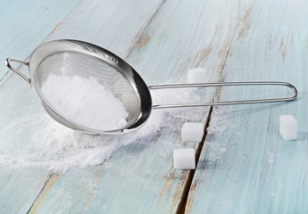 Powdered sugar in a metal sieve