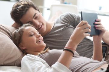 Obraz na płótnie Canvas Young couple with tablet