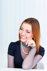 Young beautiful laughing woman looking right 