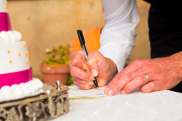 Groom Signing Marriage Certificate