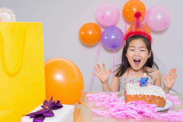 Fototapeta na wymiar Cheerful little girl at her birthday party