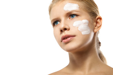 Obraz na płótnie Canvas Woman applying moisturizer cream on face isolated