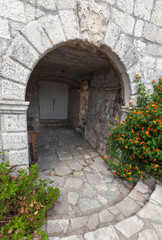 Stone arch, entrance to ancient house in Perast town, Montenegro