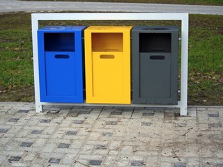 Set of colorful waste baskets in metal frame